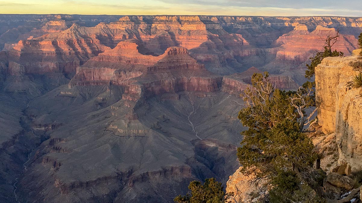 View of Grand Canyon as seen from Hermit Road on the South Rim The last light of sunset falling on the tops of cliffs and peaks within a mile-deep canyon.