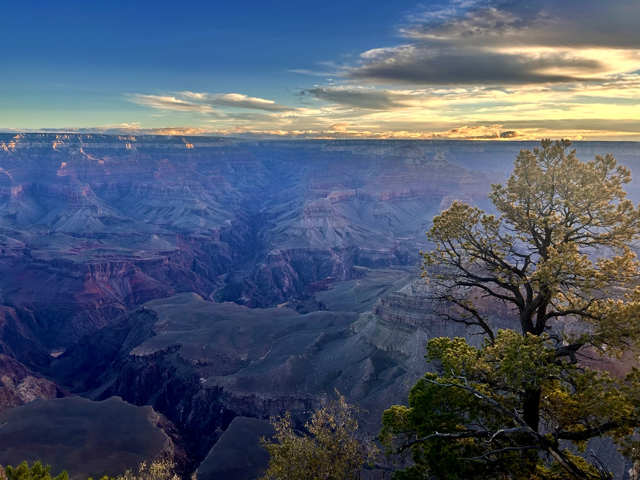 A faint sunrise over the canyon with bright angel canyon and creek in the background