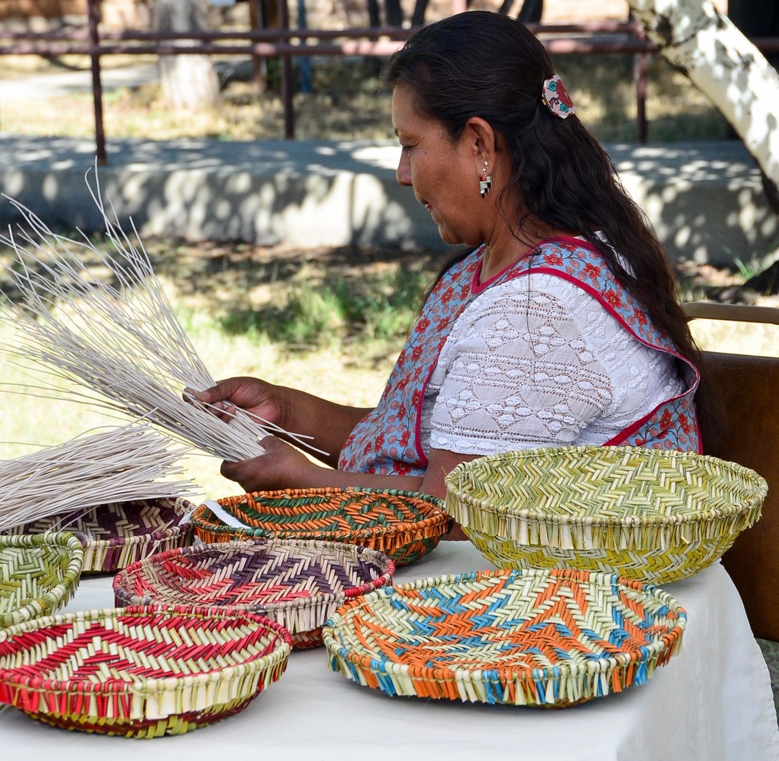 Jessica Lomatewama demonstrating basket weaving An indigenous woman demonstrating basket weaving.