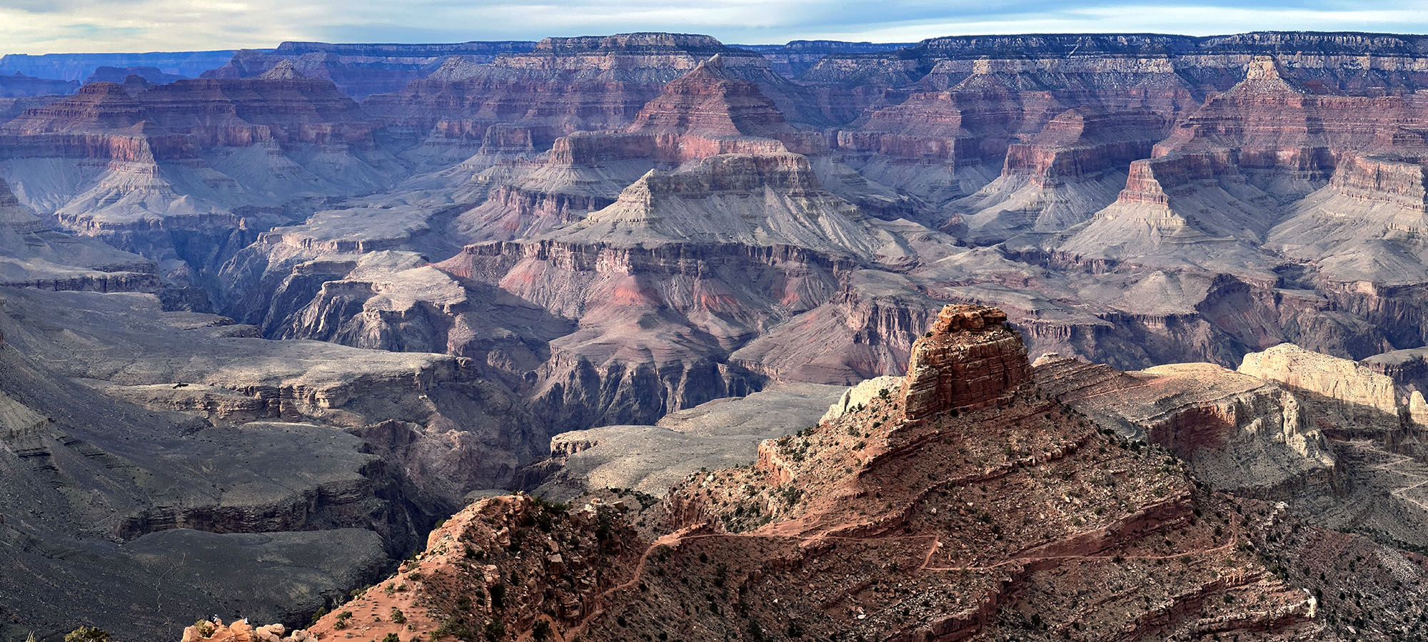 South Kaibab Trail below Cedar Ridge A canyon landscape with a trail winding down a ridgeline.