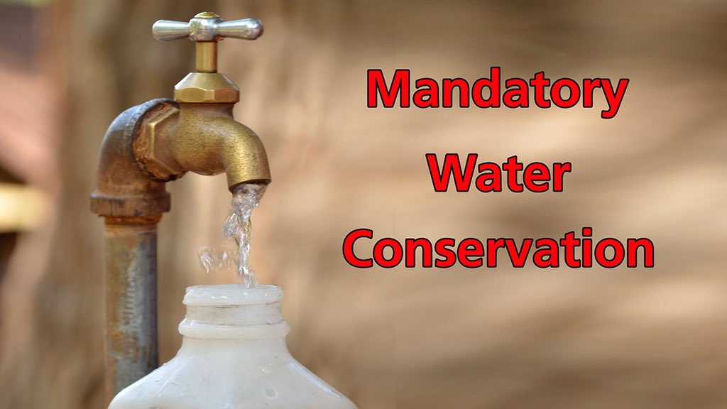 A water spigot is seen with the words "mandatory water conservation" in red bold letters
