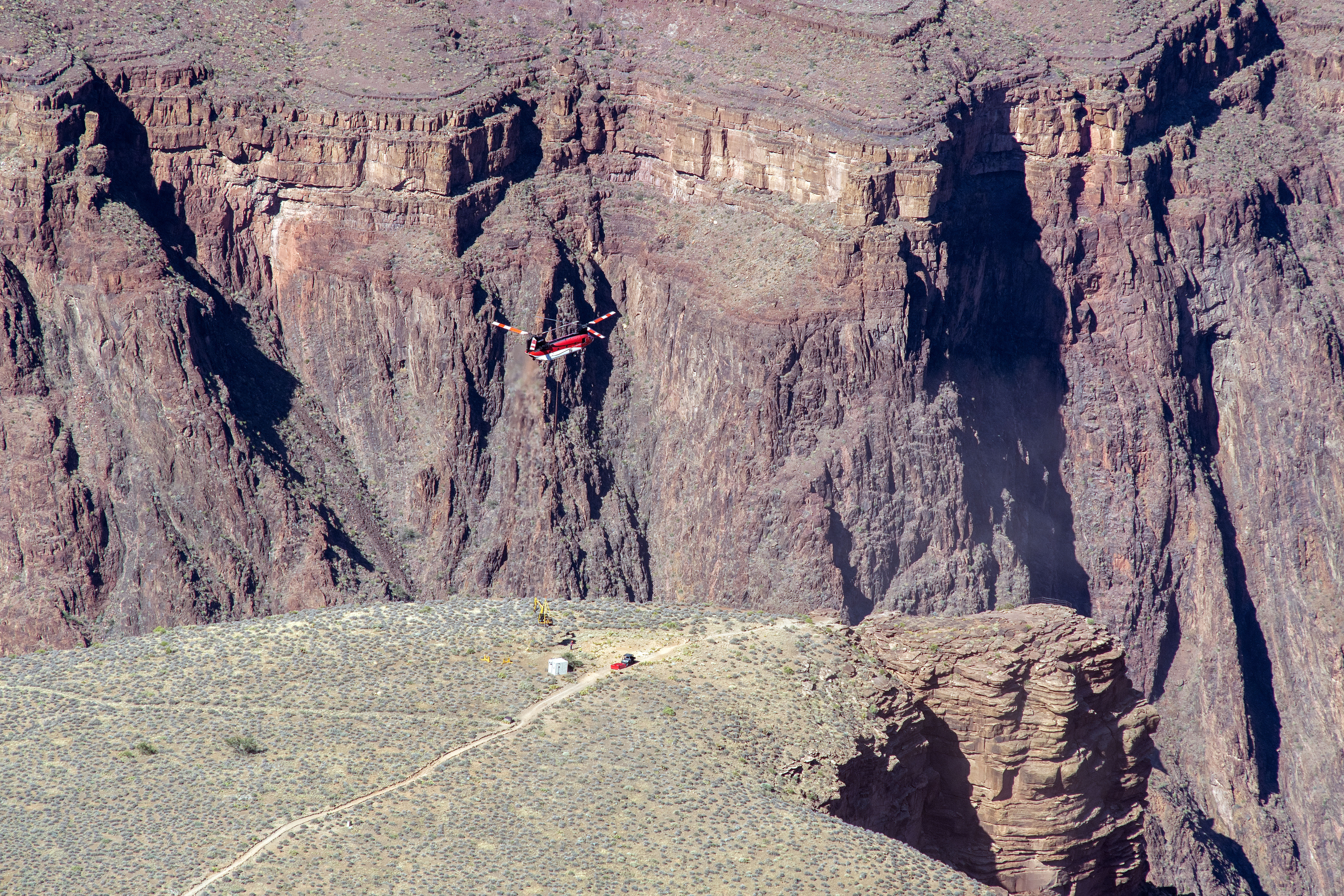 A heavy lift helicopter delivers construction equipment and materials to Plateau Point in the inner canyon