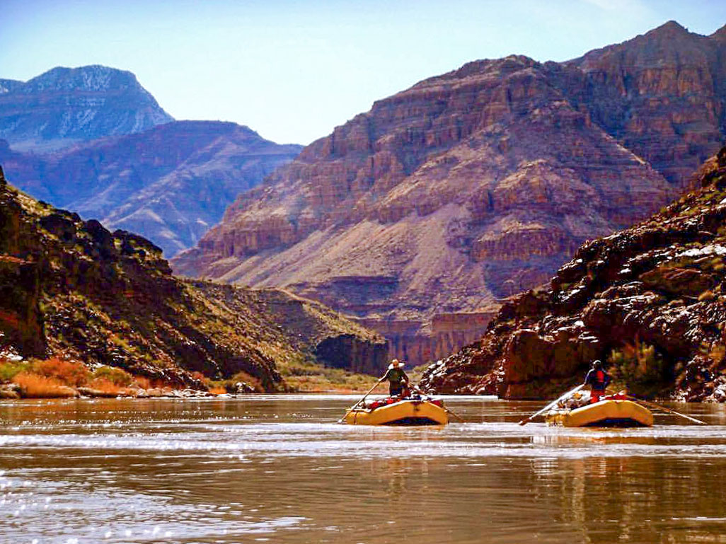 Two rafts float down the Colorado River in Western Grand Canyon
