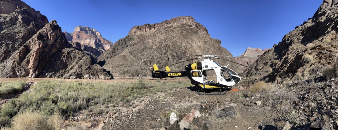 A black and yellow helicopter near Crystal Rapid along the Colorado River