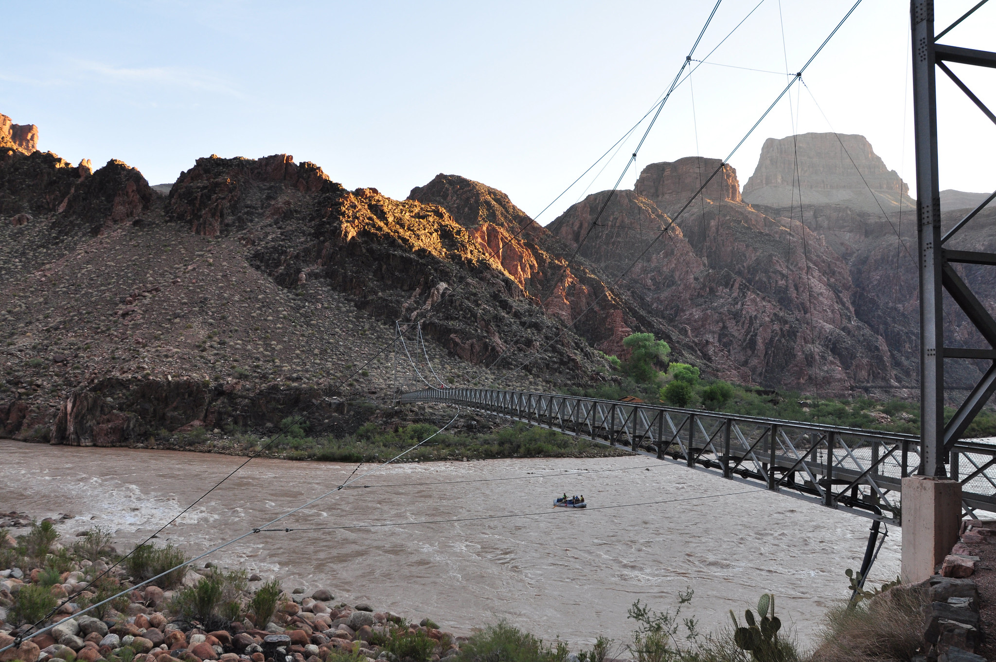 Silver Bridge Boaters on the Colorado River pass under the Silver Bridge while getting an early start on their day's journey. NPS Photo by Erin Whittaker.