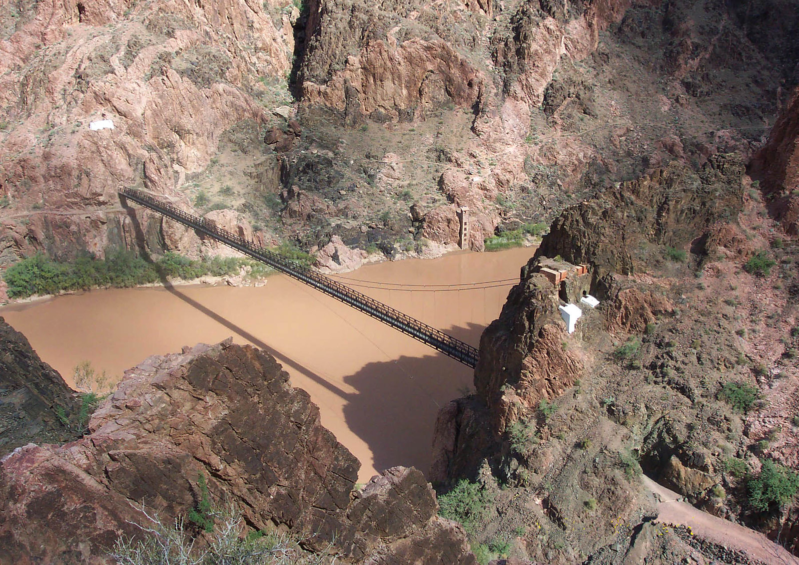 View looking towards the Colorado River from the South Kaibab Trail. The Kaibab Suspension Bridge can be seen spanning the length of the Colorado River.