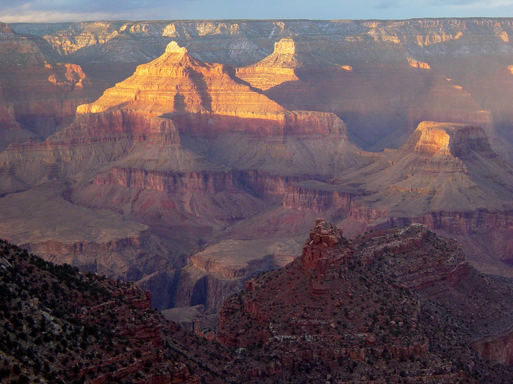 South Rim Scenic Sunset The sun sets on the canyon. Buttes and mesas rise in the distance.