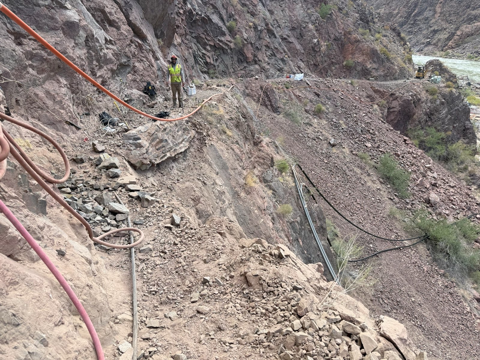 A narrow band of trail above a river with a rockslide approximatley 50 ft. wide.