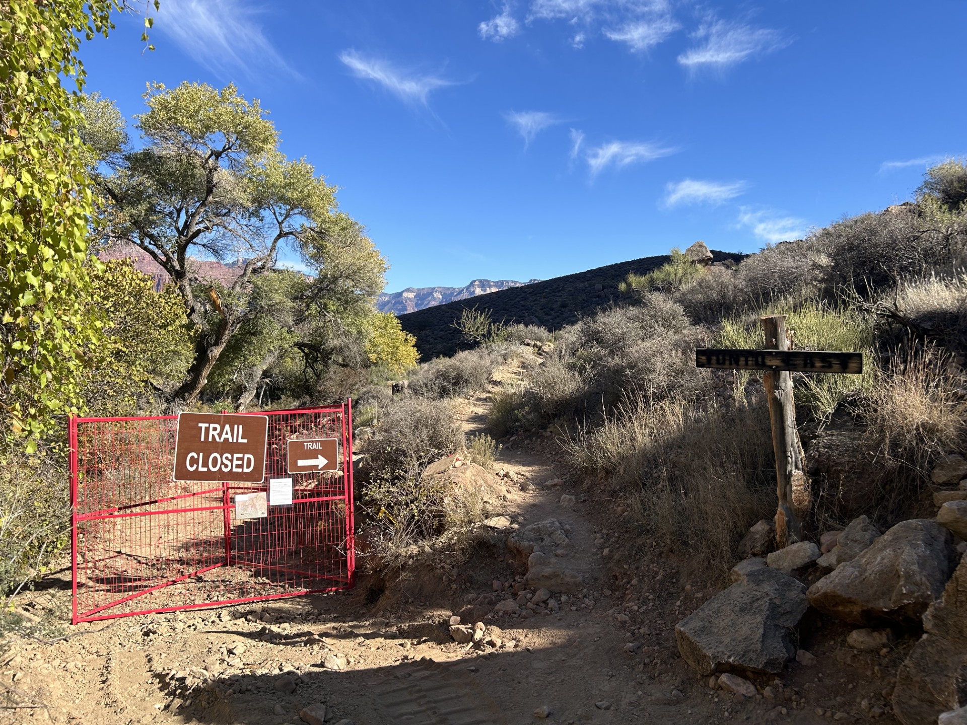 A 'trail closed' sign on a trail in the inner canyon