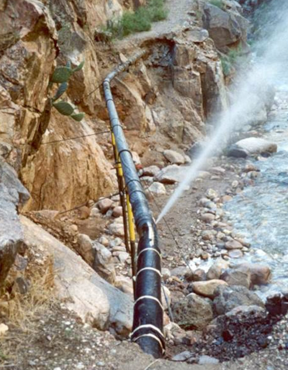 a gush of water spews out of a broken transcanyon waterline