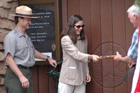 Cutting the ribbon to unveil the new exhibits.