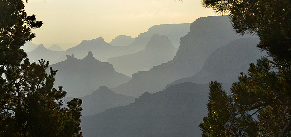 Sunset view to the west from Desert View Point. NPS/M.Quinn a series of silhouetted peaks and ridgelines, receding into the distance
