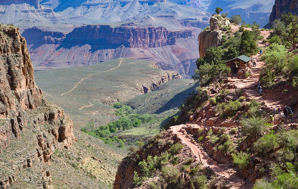 Three-Mile Resthouse Image of the Three-Mile Resthouse with a vast canyon landscape in the background