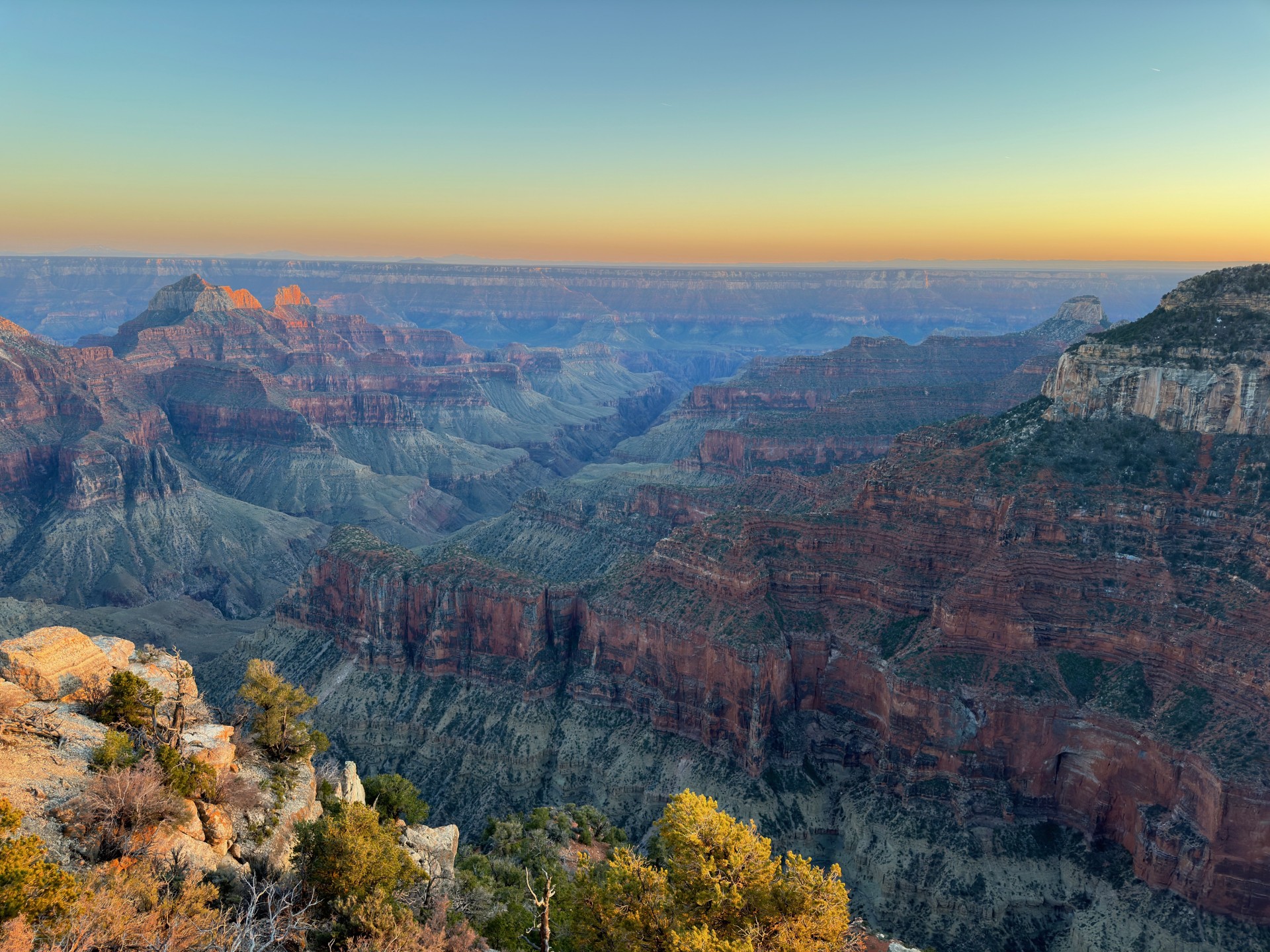 A sunset with a vibrant mix of color from the North Rim showing a spectacular canyon landscape below