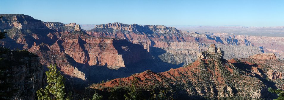 Panoramic view of two prominent peaks with cliffs in the background.