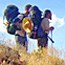 Hikers, with full packs, pausing on the trail.