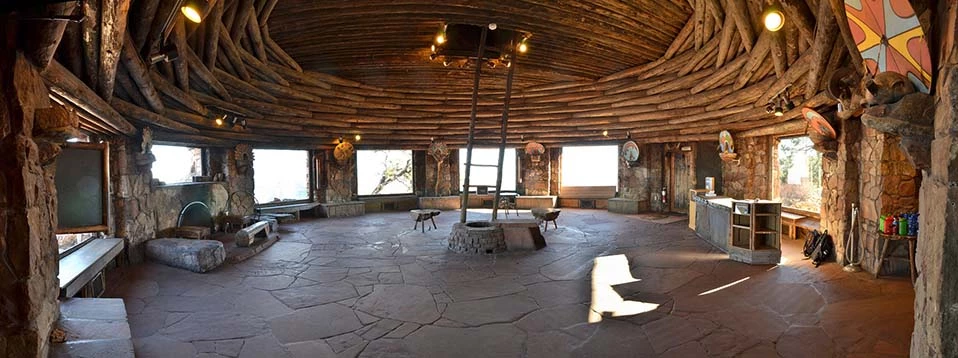Watchtower Kiva Room A wide open circular room with a flagstone floor. Large picture windows take up about 2/3 of the circumference of the circle. Windows are separated by stone pillars. The ceiling is made up of inter-woven logs that surround, then arch over the round room.