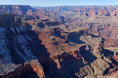 Red cliffs speckled with snow.