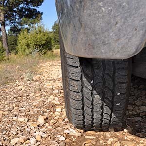 rear view of an off-road jeep tour tire on a dirt road.