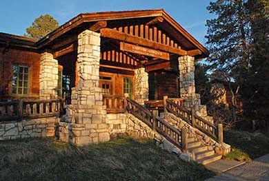 Flight of stairs leads up to front entrance of rustic stone and log North Rim visitor center.