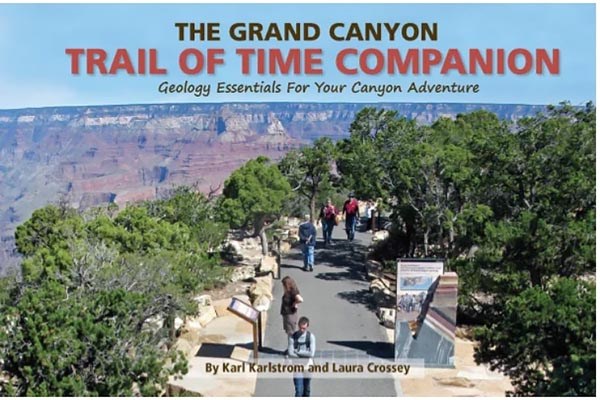 Book cover of the Trail of Time Companion shows people walking along a paved trail with outdoor exhibits and rock specimens on concrete plinths.
