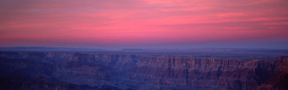 The sun set behind the canyon at sunset.