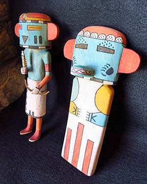 two human-like kachina doll figures carved from wood and painted in bright primary colors.