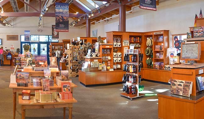 interior of a large gift shop that features books, gifts, and some outdoor clothing.