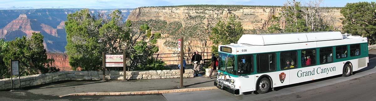 Hermit Road shuttle at Monument Creek Overlook stop. Canyon on left, bus on right.