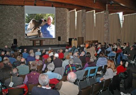 audience watching a lecture with slide show in the auditorium.