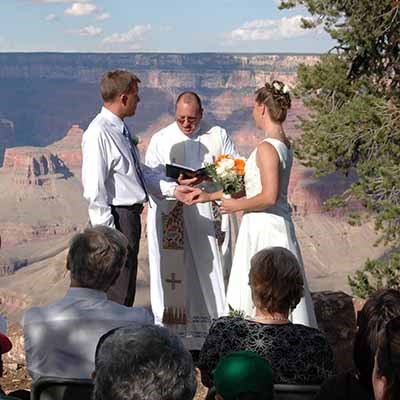 Two people getting married on the rim of Grand Canyon.