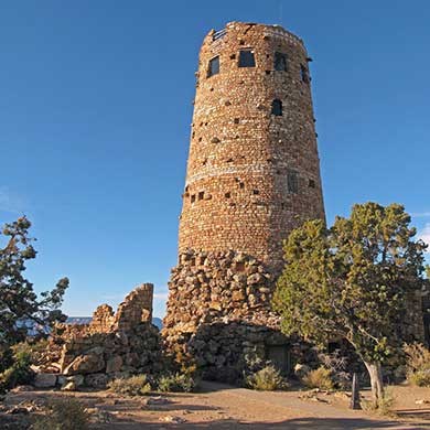 Front side of Watchtower as seen from ground level looking up. to the left is the wall of partially collapsed structure. A partial glimpse of Grand Canyon barely seen boyond the tower.