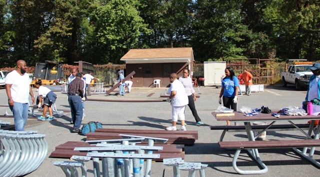 Volunteers assembling a picnic table