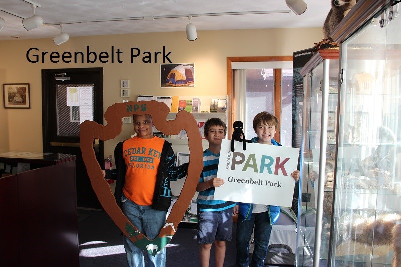 Junior Rangers with Arrowhead and Find Your Park sign