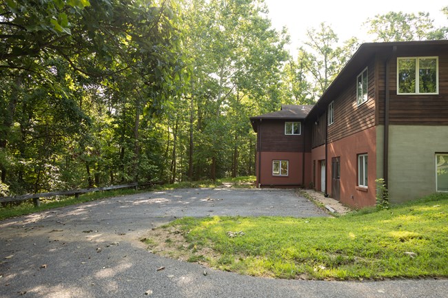 A parking lot sits behind a ranger station