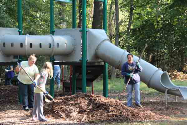 Maryland Geocaching Society volunteers spreading woodchips at the Sweetgum Picnic Area in Greenbelt Park, Maryland