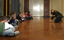 Park ranger teaching students a Native game.