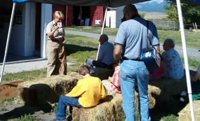 A park volunteer teaching children how to read brands while playing brand bingo.