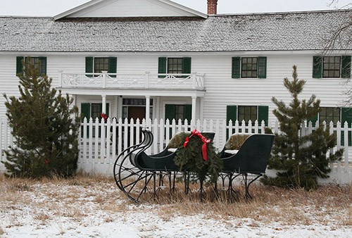 Sleigh in front of main ranch house.