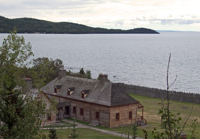 Historic buildings on a bay with a peninsula showing an island on the horizon.