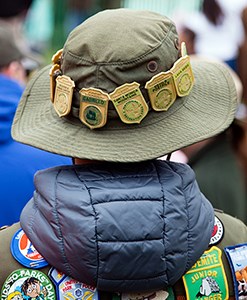 Back view of a child wearing a hat with badges.