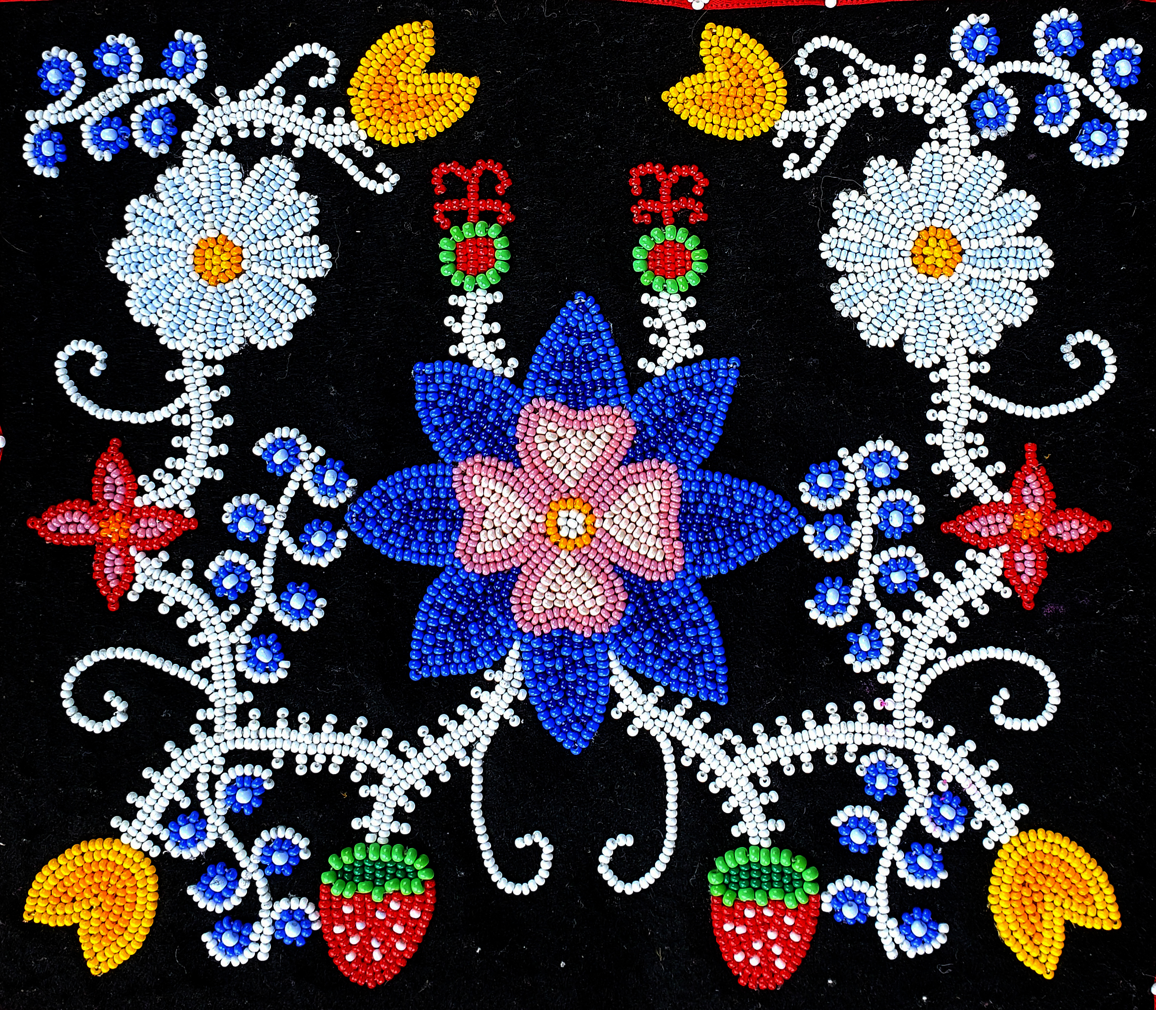 Multi-colored beaded floral pattern on a black background.