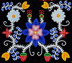 Multi-colored beaded floral pattern on a black background.