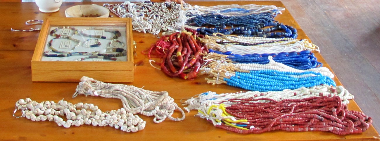 Strands of colored beads lying on a table.