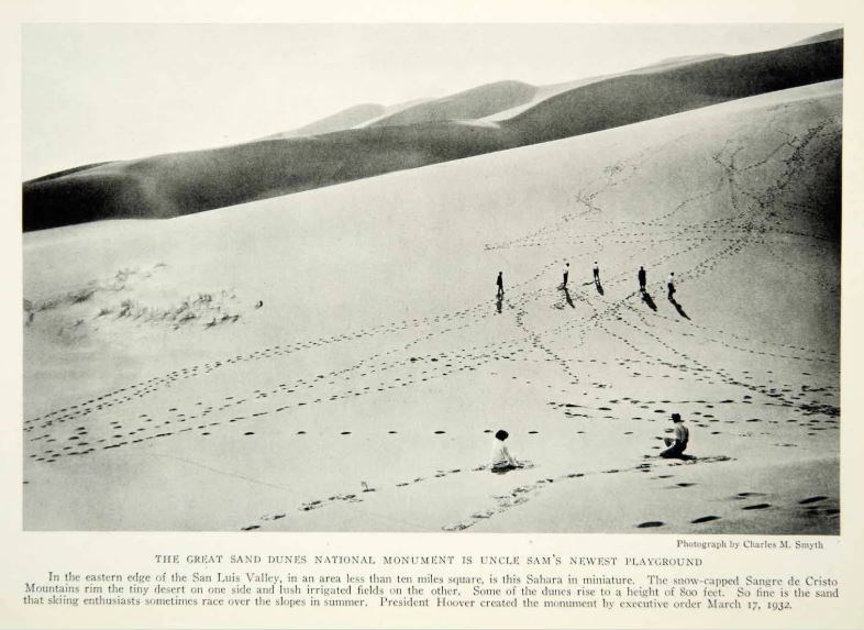 People attempt to climb the sand dunes in 1932.