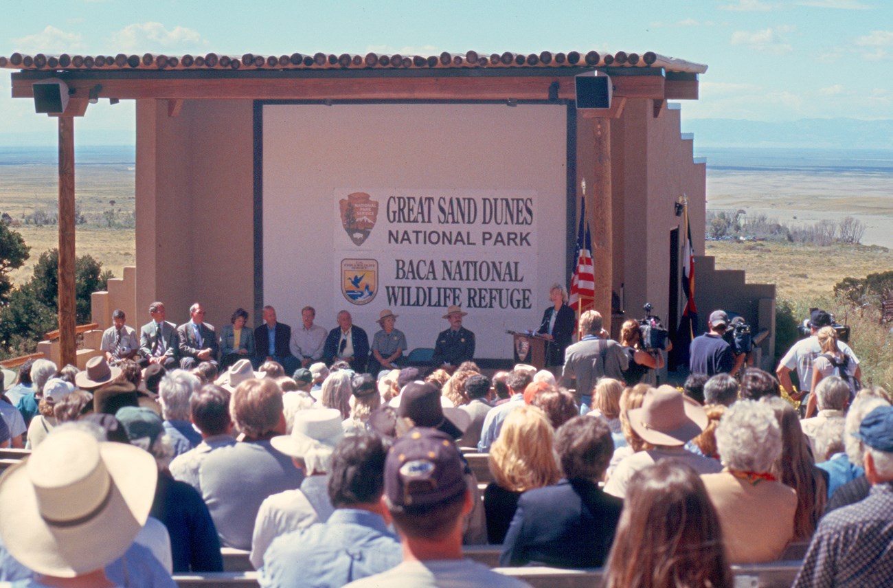 A large crowd at the park amphitheater listens to Gale Norton formally designate Great Sand Dunes as a National Park