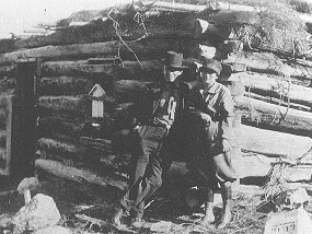 Man and woman by cabin at the base of Mosca Pass
