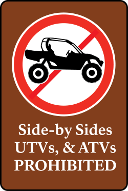 Symbol with ATV with red slash with text side by sides, UTVs and ATVs Prohibited
