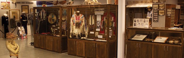 An image of multiple cultural exhibits along a wall in a museum