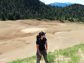 Woman Hiking Dunes near Forest